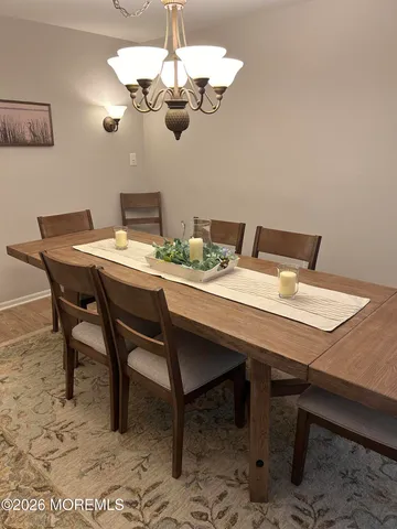 a view of a dining room with a table and chairs