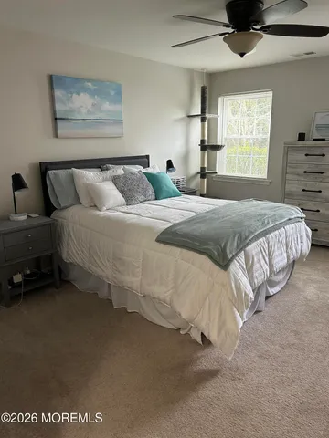 a bedroom with bed and window