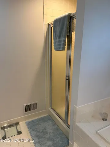 a bathroom with a shower and mirror