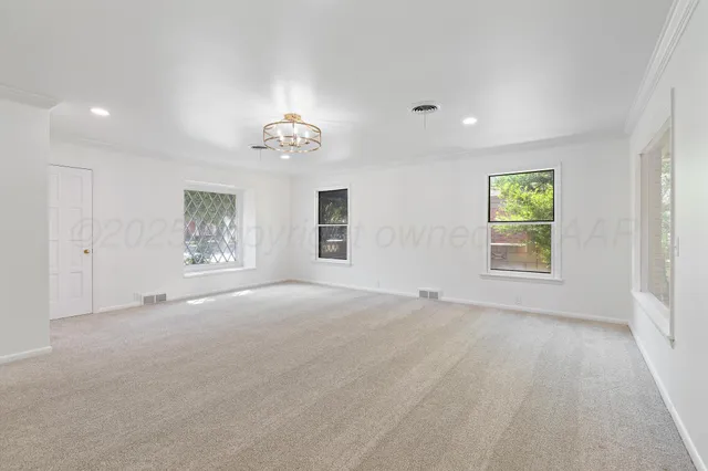 a large kitchen with stainless steel appliances granite countertop a lot of counter space and wooden floor
