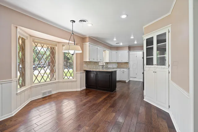 a kitchen with granite countertop stainless steel appliances and cabinets