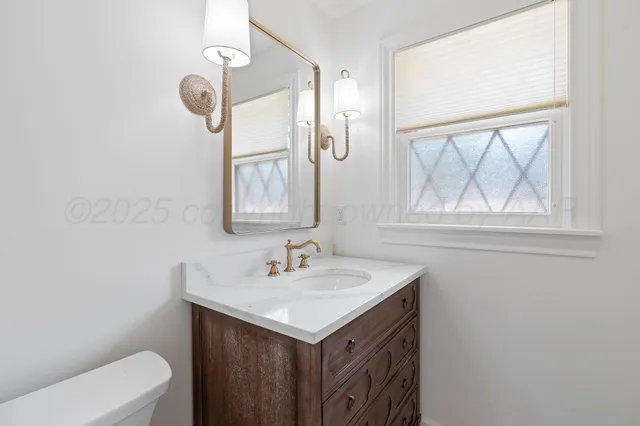 a bathroom with a sink a mirror and a window