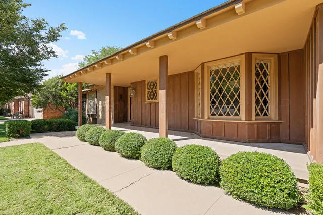 an empty room with fireplace and windows