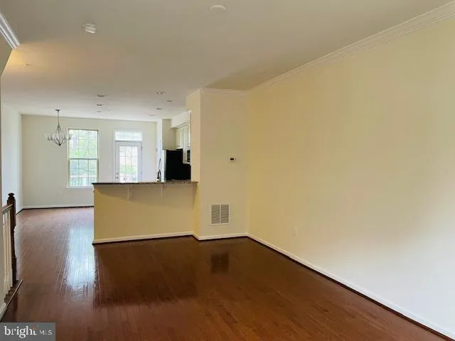 a kitchen with granite countertop a sink a counter space appliances and cabinets