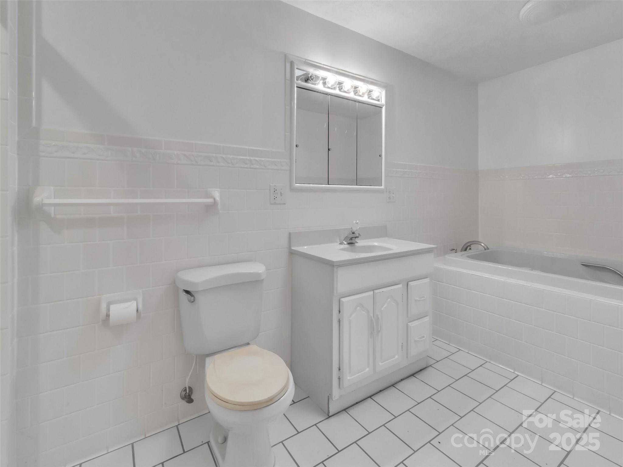 18 Sierra Point Waynesville, NC 28786 - Photo 17 of 48 a bathroom with a sink toilet and vanity