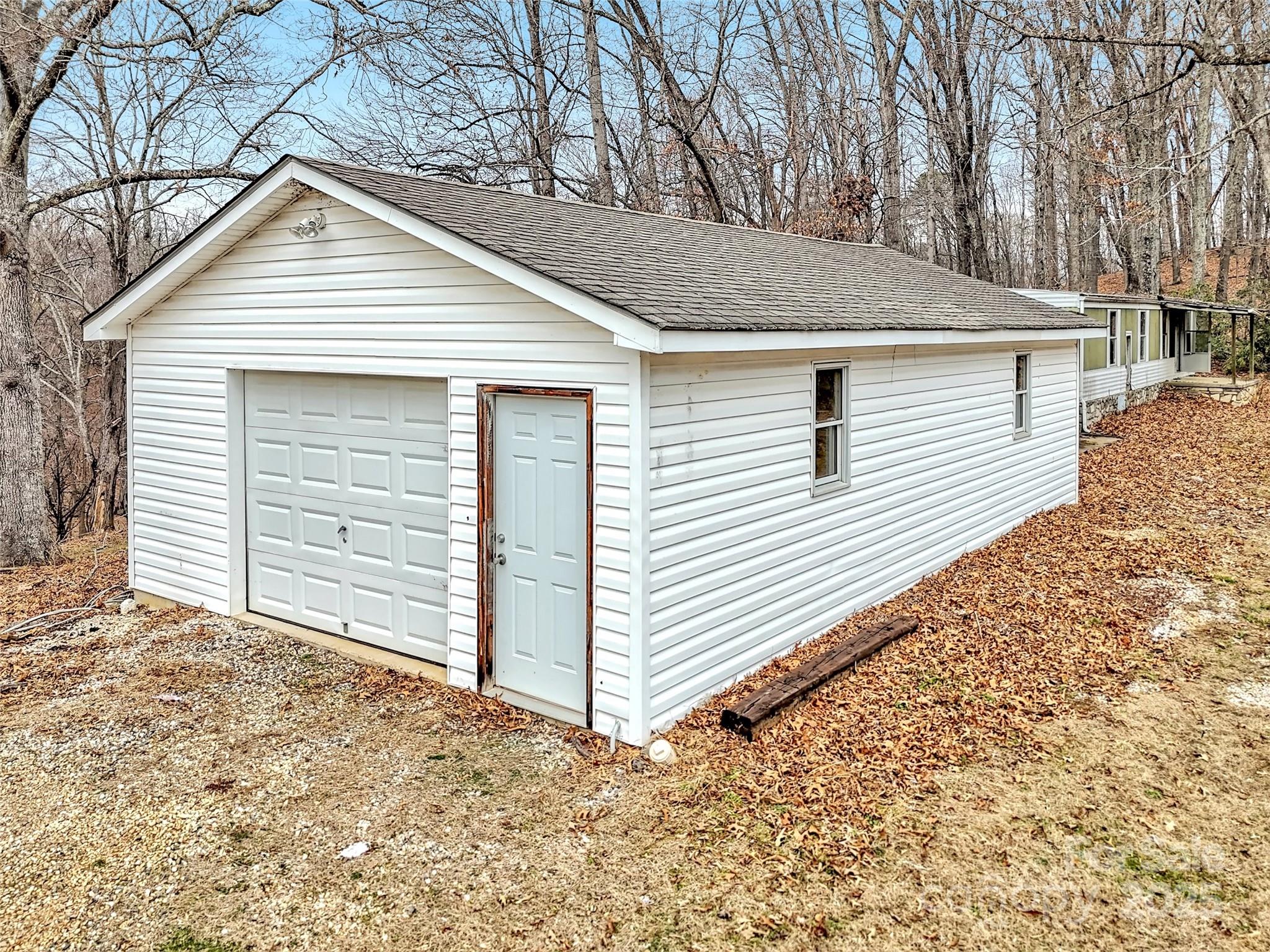 18 Sierra Point Waynesville, NC 28786 - Photo 33 of 48 a view of a white house with a small yard and large tree