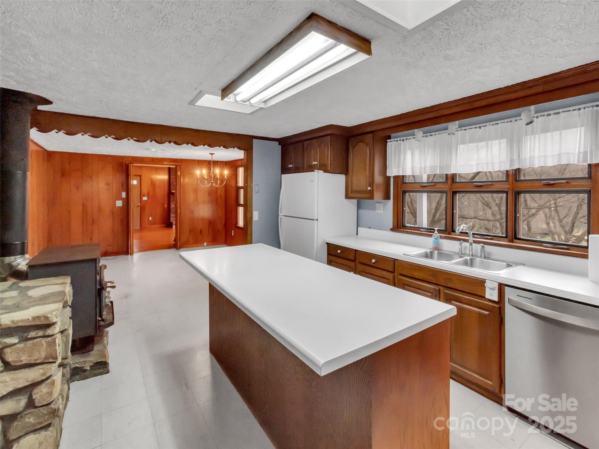 18 Sierra Point Waynesville, NC 28786 - Photo 6 of 48 a kitchen that has a sink a table and chairs in it