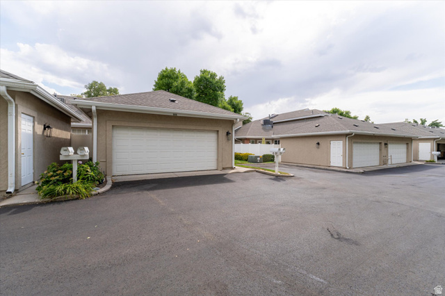 888 East 6895 South Midvale, UT 84047 - Photo 29 of 54 Spacious attached garage with convenient access and additional parking, providing practical storage and functionality.