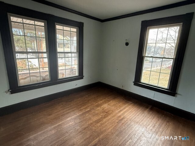 66 South 3rd Street Meriden, CT 06451 - Photo 3 of 12 a view of an empty room with wooden floor and a window
