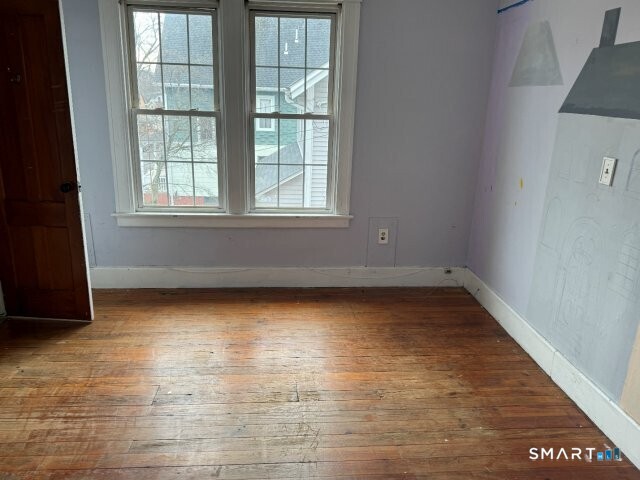 66 South 3rd Street Meriden, CT 06451 - Photo 8 of 12 an empty room with wooden floor and windows