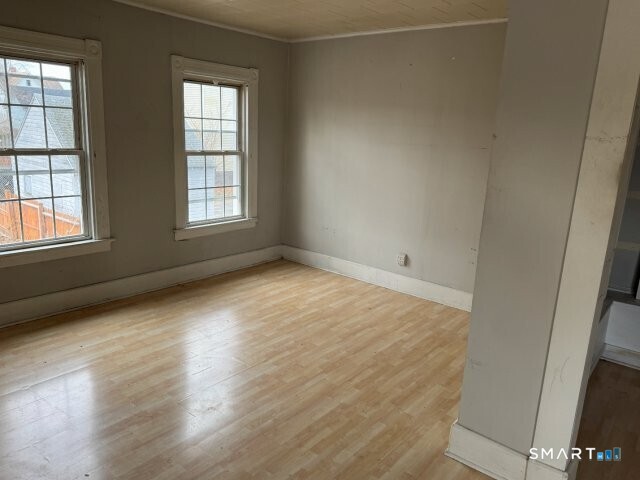 66 South 3rd Street Meriden, CT 06451 - Photo 10 of 12 an empty room with wooden floor and windows