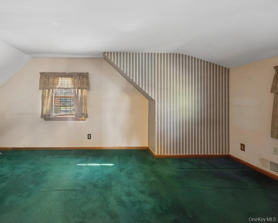 43 Briarcliff Road Westbury, NY 11590 - Photo 11 of 15 an empty room with wooden floor and windows