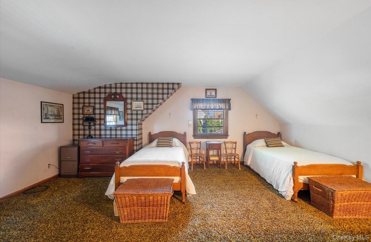 43 Briarcliff Road Westbury, NY 11590 - Photo 13 of 15 a bedroom with a bed and lamp