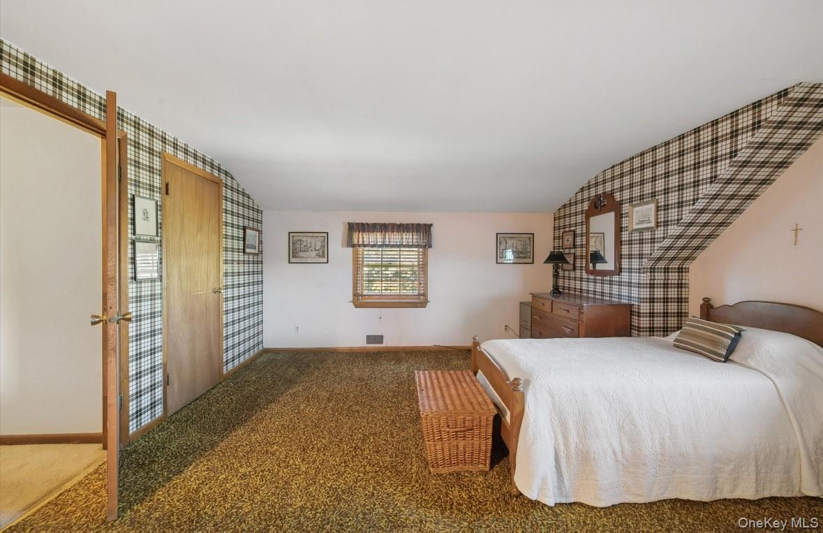 43 Briarcliff Road Westbury, NY 11590 - Photo 14 of 15 a bedroom with a bed and a window
