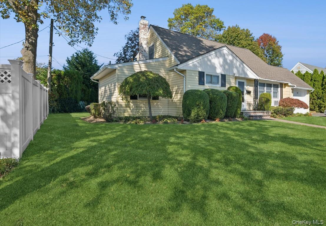 43 Briarcliff Road Westbury, NY 11590 - Photo 2 of 15 a view of a house with a big yard potted plants and large tree