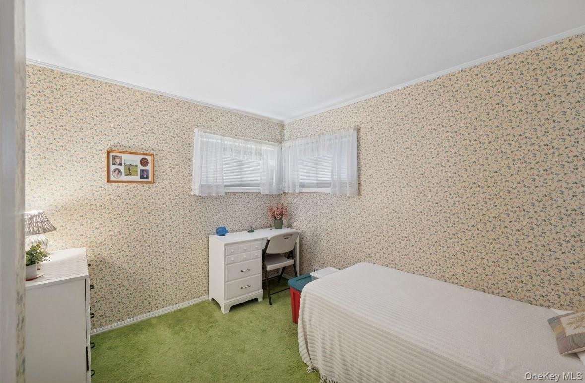 43 Briarcliff Road Westbury, NY 11590 - Photo 9 of 15 a bedroom with a bed and a cabinets