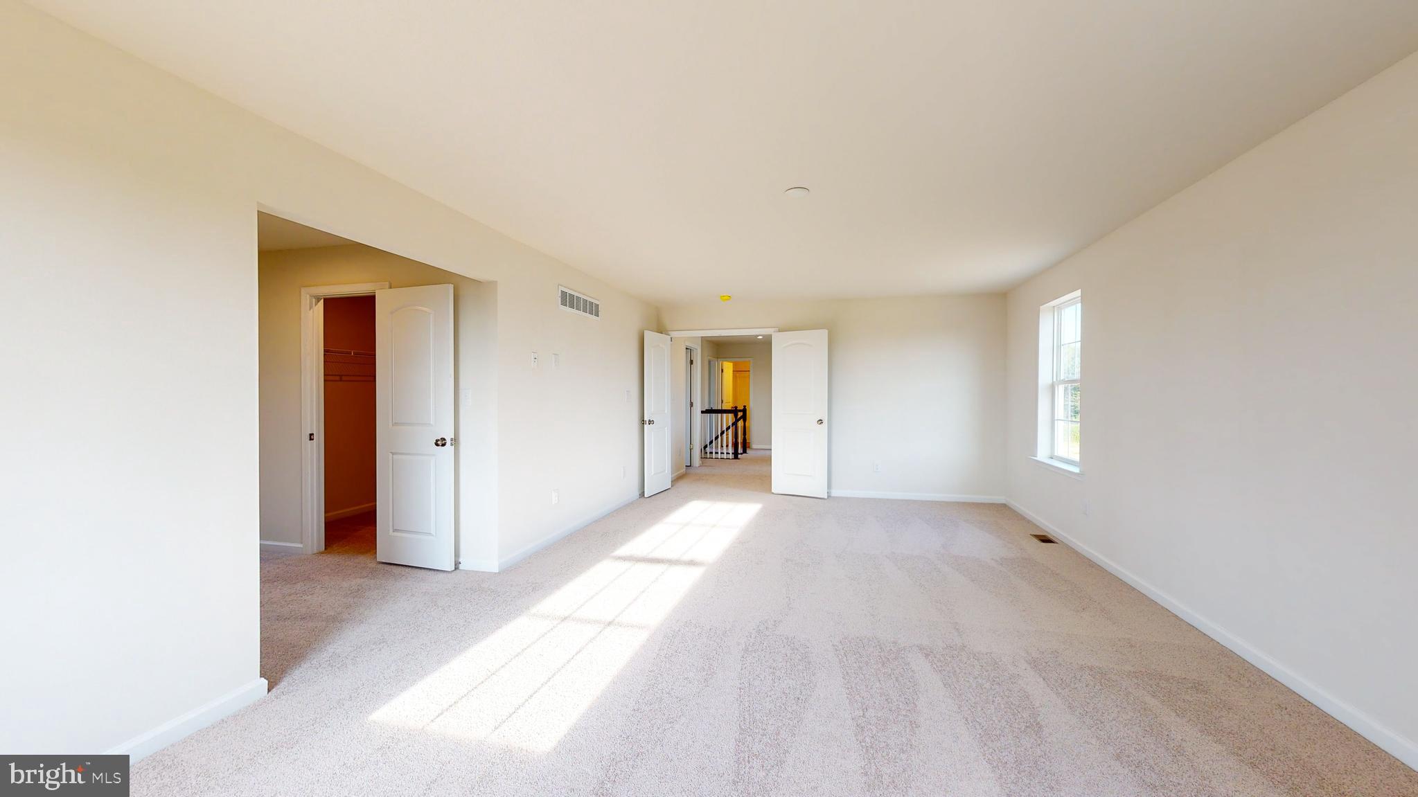 211 Laks Court, Unit CHARLESTON Smyrna, DE 19977 - Photo 12 of 24 a view of empty room with wooden floor and window
