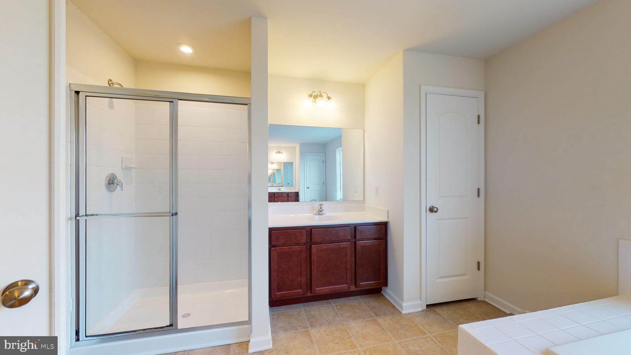 211 Laks Court, Unit CHARLESTON Smyrna, DE 19977 - Photo 14 of 24 a bathroom with a sink and mirror