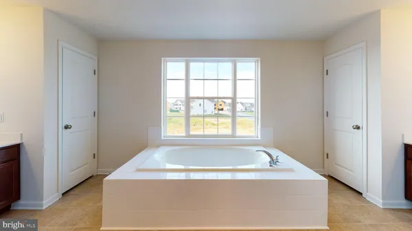 a view of bathroom with bathtub and window