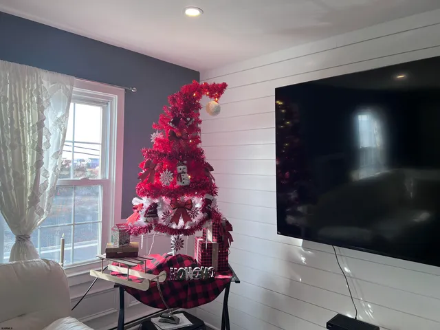a living room with furniture a fireplace and wooden floor