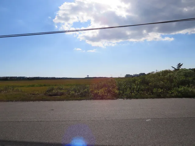 a kitchen with granite countertop a refrigerator stove top oven and sink