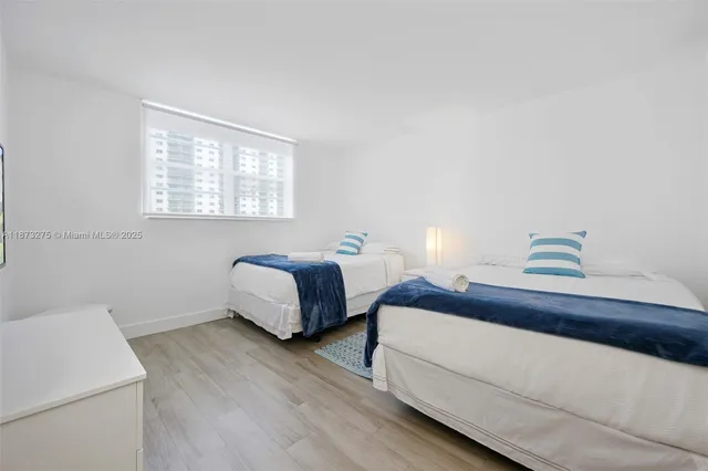 a bedroom with bed and a window