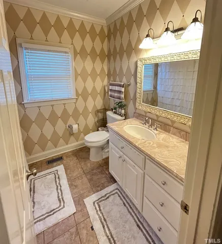 a bathroom with a sink a toilet a mirror and shower