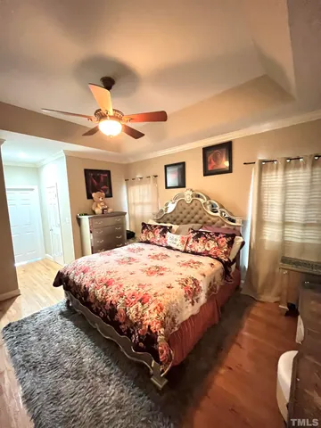 a spacious bedroom with a large bed and a dresser