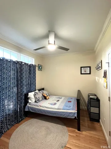 a bedroom with a bed and wooden floor