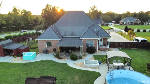 a aerial view of a house with a yard table and chairs