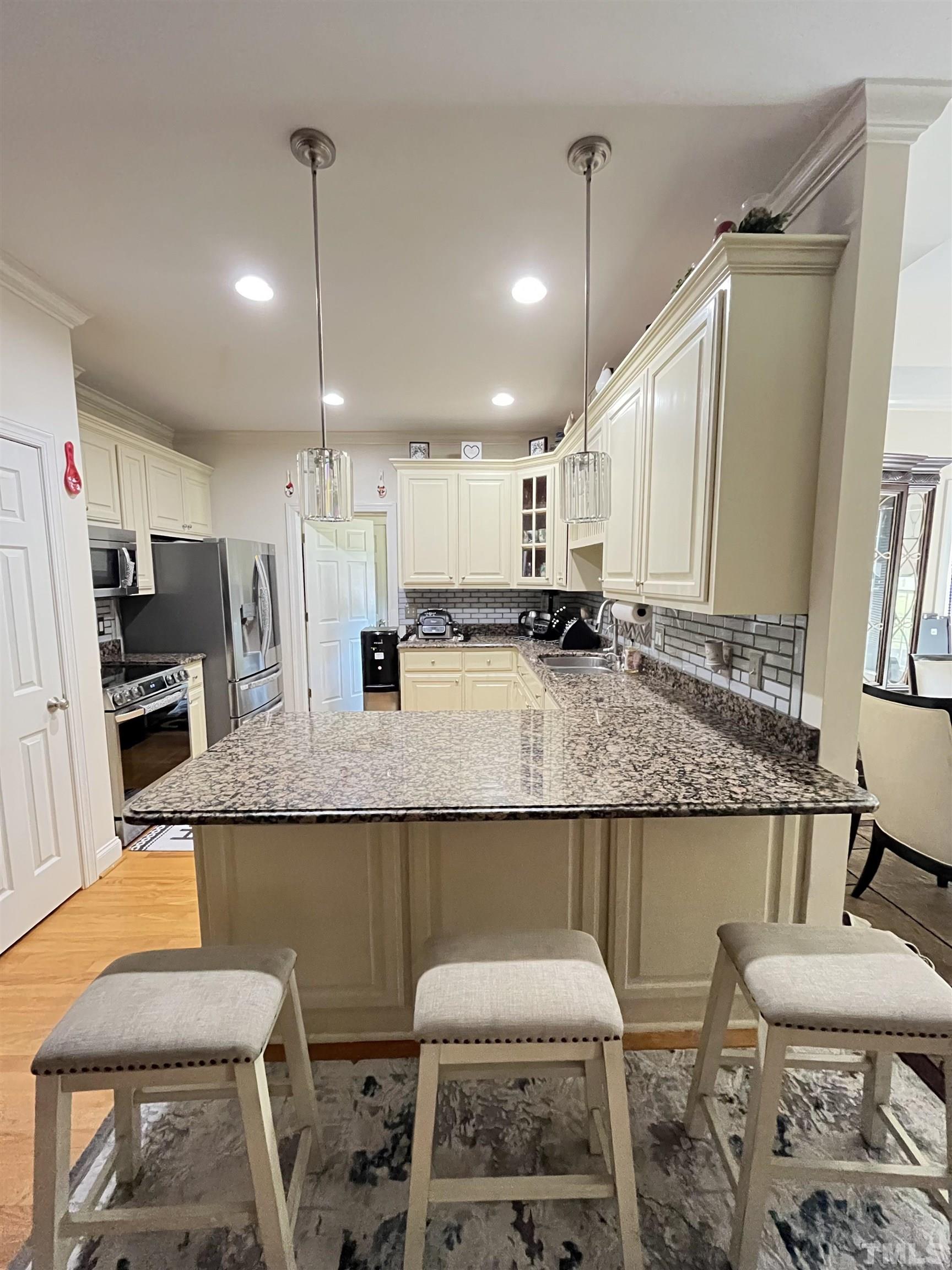 3098 Creek Point Road Haw River, NC 27258 - Photo 21 of 21 a kitchen with granite countertop kitchen island stainless steel appliances a sink and counter space
