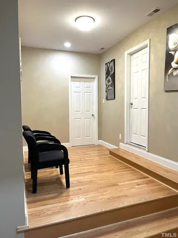 a room with a piano and wooden floor