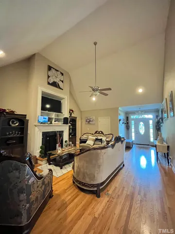 a living room with furniture a fireplace and a flat screen tv