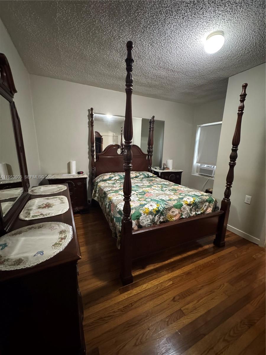 322 Southwest 31st Court Miami, FL 33135 - Photo 14 of 21 a bed sitting in a bedroom next to a window