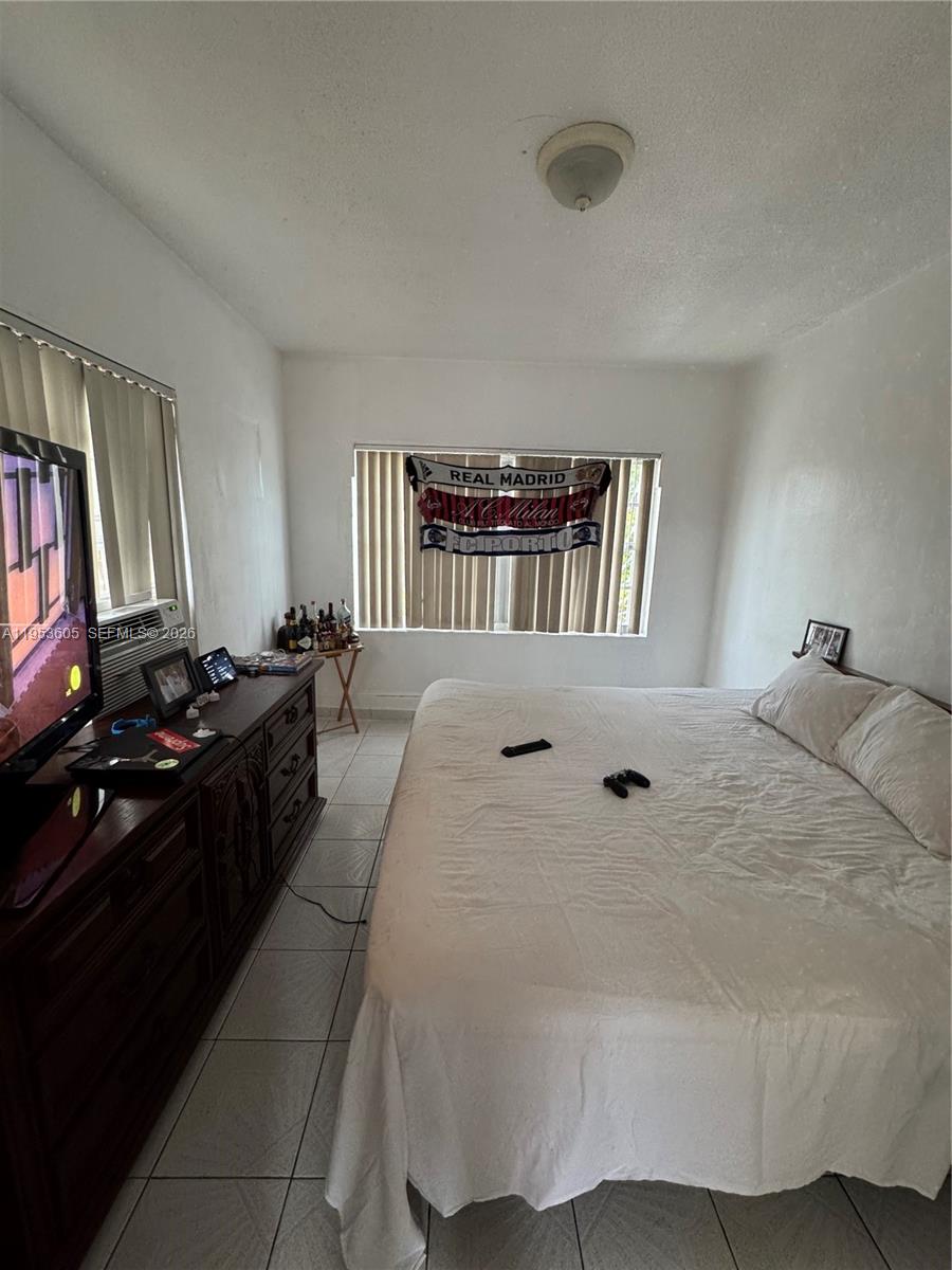 322 Southwest 31st Court Miami, FL 33135 - Photo 16 of 21 a bed room with a bed and a book shelf