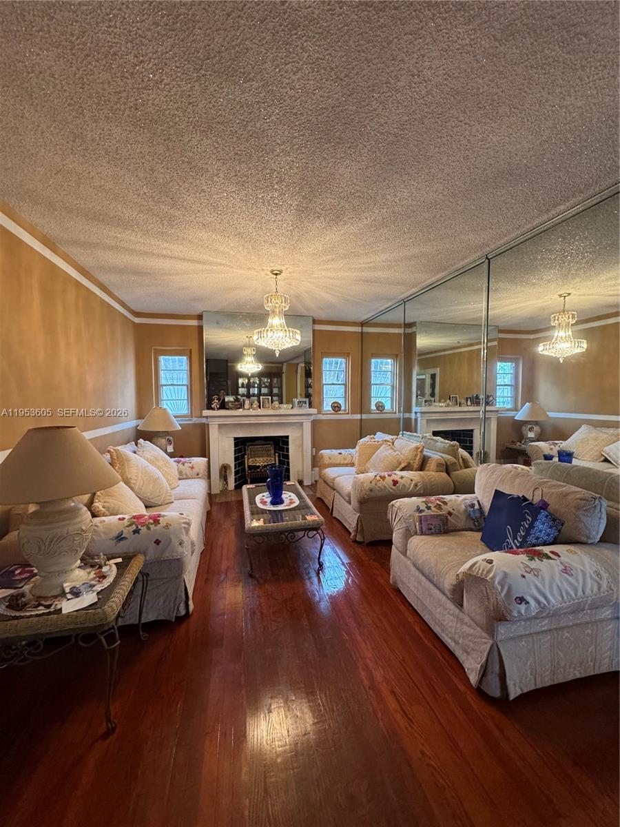 322 Southwest 31st Court Miami, FL 33135 - Photo 5 of 21 a living room with furniture and a fireplace