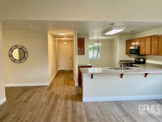 Undisclosed Address Bakersfield, CA 93313 - Photo 2 of 11 a view of kitchen with wooden floor and window