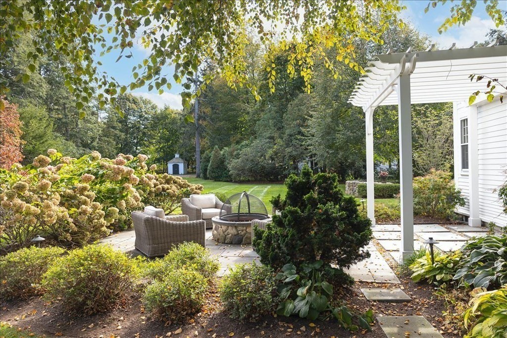 346 Main Street Hingham, MA 02043 - Photo 36 of 42 a backyard of a house with large trees and plants