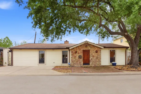 front view of a house with a tree