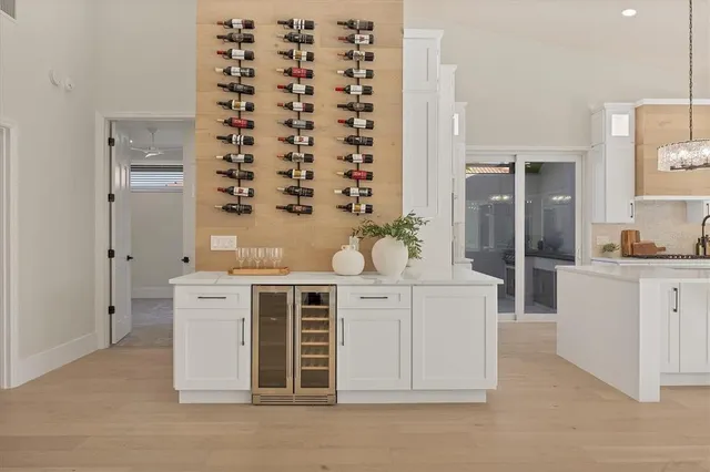 a bedroom with a large bed and a potted plant