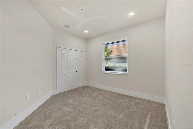 a view of a backyard with table and chairs under an umbrella