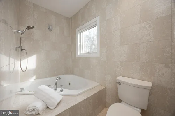 a white toilet sitting next to a bath tub shower