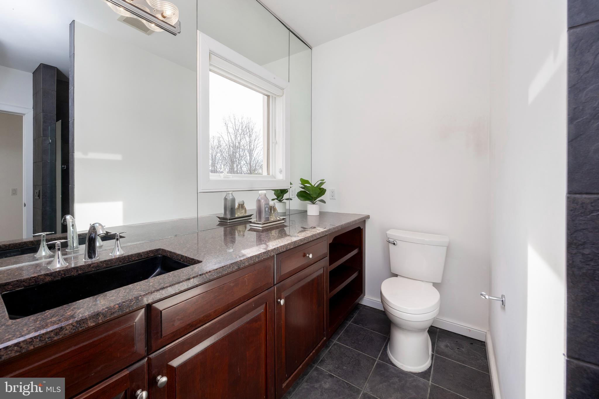 115 Bullock Road Chadds Ford, PA 19317 - Photo 23 of 50 a bathroom with a granite countertop toilet sink and mirror