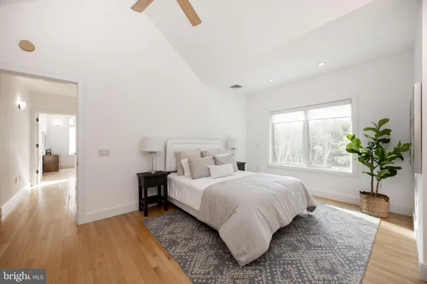 a bedroom with a bed and a potted plant