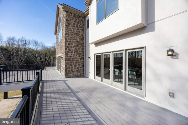 a view of balcony with wooden floor and fence