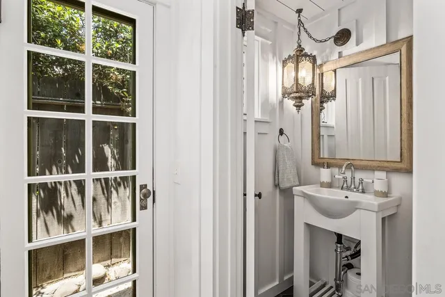 a bathroom with a sink a mirror and a window