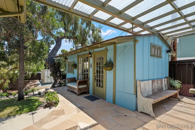 a view of a patio with couches and table and chairs and potted plants