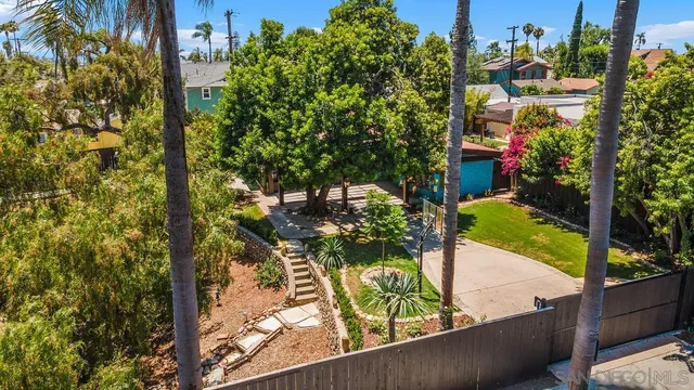an aerial view of residential houses with outdoor space