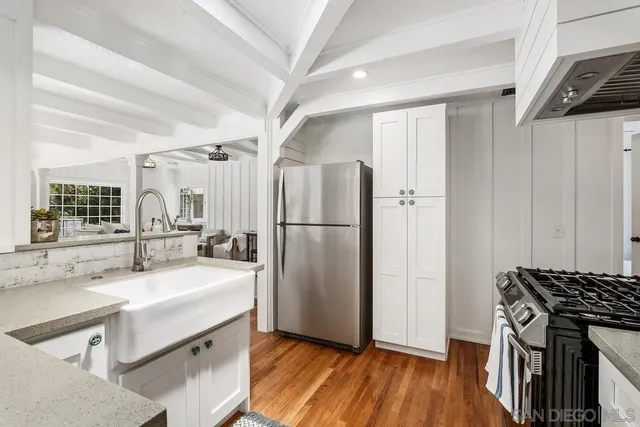 a kitchen with a sink appliances and cabinets