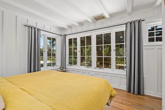 a bed sitting in a bedroom next to a window